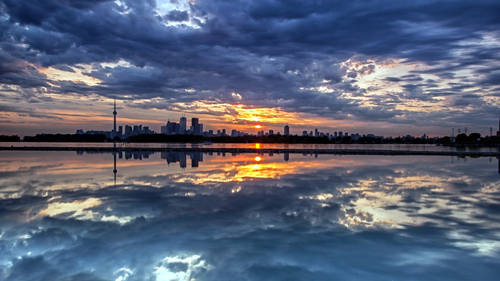 sun over city reflection